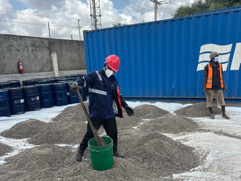 Field team weighing and sampling raw ore at a buying center
